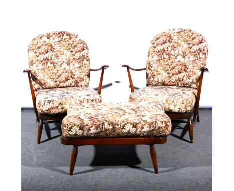 A pair of Ercol stained beechwood Windsor type easychairs, tapestry pattern upholstery, width 71cm; and a similar footstool. 