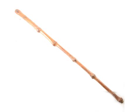 A briarwood walking stick, carved with a face, initialled C.W., 82cm.