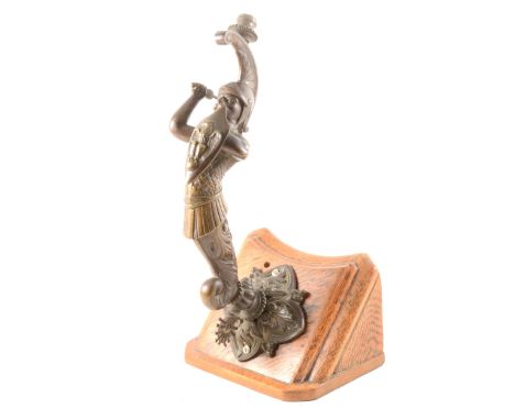 A Victorian bronzed gas lamp, figure with a shield, diamond registration mark, on oak mount, 32cm.