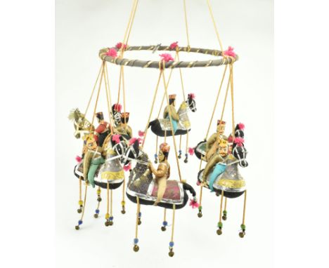 A vintage 20th century Indian Kathputli style hanging nursery mobile. The mobile featuring seven fabric riders atop horses, e