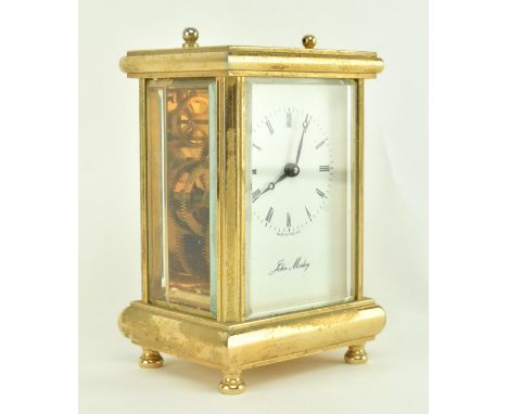 A vintage circa 1980s brass and glazed mantlepiece or desktop carriage clock. The clock with bevelled glass panels fixed in a
