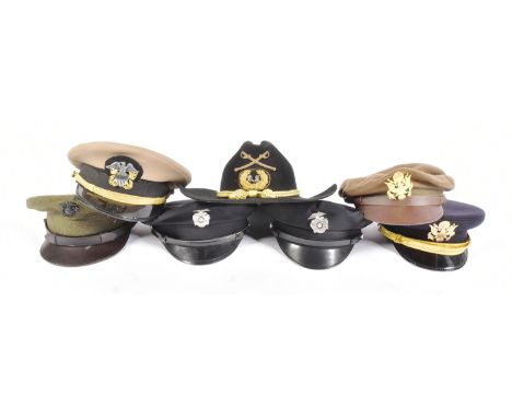 A collection of reenactment US United States Military uniform peaked cap visors to include Army Officer Service cap, Tropical