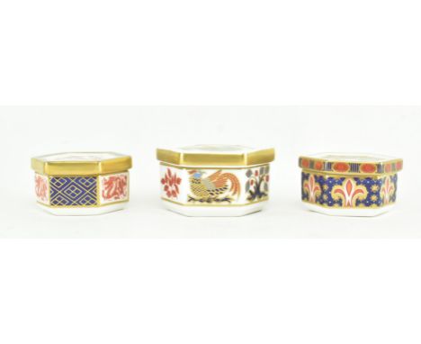 Royal Crown Derby - Three fine bone china hexagonal lidded trinket boxes, to include one with decoration of a phoenix, with p