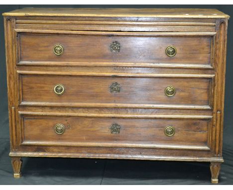 An 18th century French oak chest of three drawers, brass roundel escutcheons, ring handles, tapering forelegs, circa 1780.