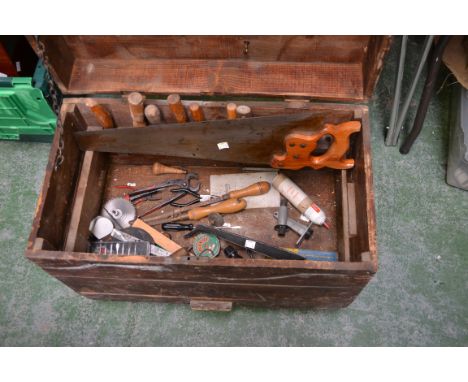 A pine tools chest, on wheels, containing an assortment of carpentry tools