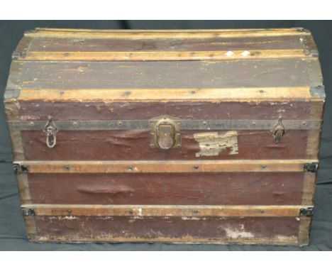 A metal bound domed top travelling trunk, initialled KW