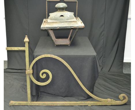 A large cast iron wall mounted lantern bracket, circa 1900; an outside lantern. (2)