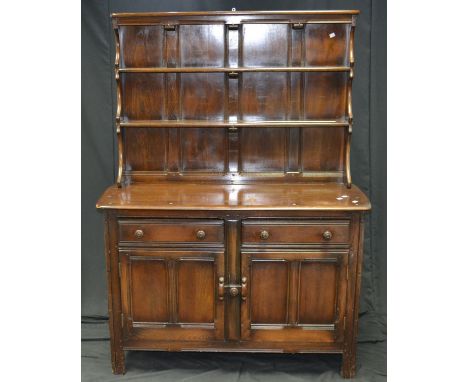 An Ercol oak dresser, two shelves top, two short drawers over two door cupboard to base, stile feet. 166cm high x 123cm wide 