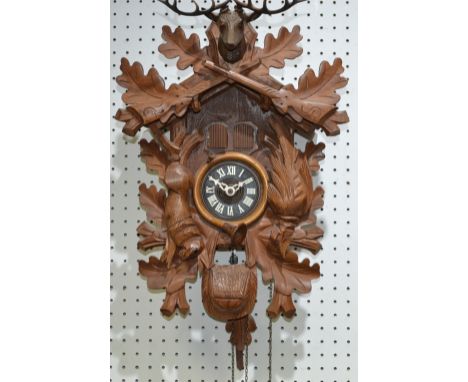 A hand carved cuckoo clock, made in Switzerland, with Thorens movement and Blue Danube tune