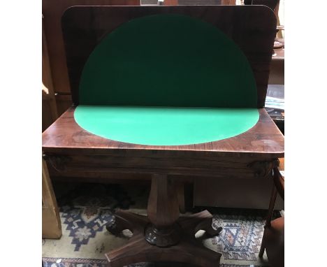 A Victorian rosewood card table, the top opening to circular baize playing surface 