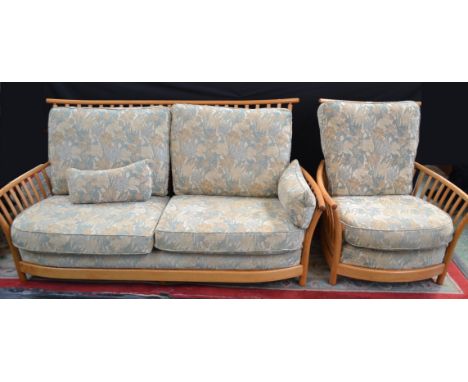 An Ercol Rennaissance two seat settee and a conforming armchair.