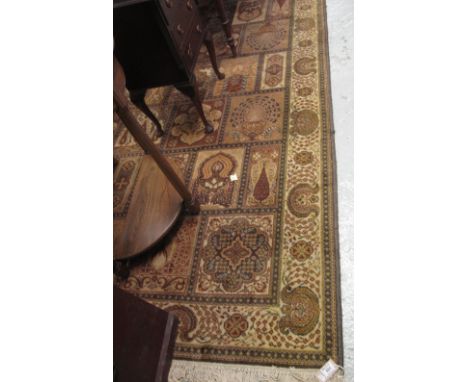 Large Middle Eastern design mustard ground carpet, the rectangular panels decorated with stylised birds and foliage.(B.P. 24%