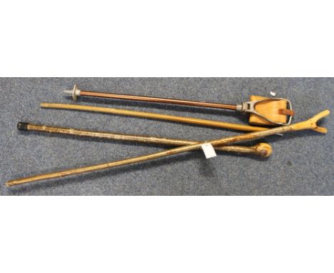 Two wooden walking sticks with silver mounted knops, together with a wooden type crook and a vintage folding shooting stick. 