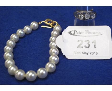 9ct gold cubic zirconia ring and a simulated pearl bracelet with gold clasp.(B.P. 24% incl. VAT)