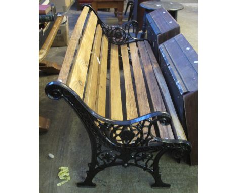 Garden bench with oak slats and cast iron pierced supports.(B.P. 24% incl. VAT)