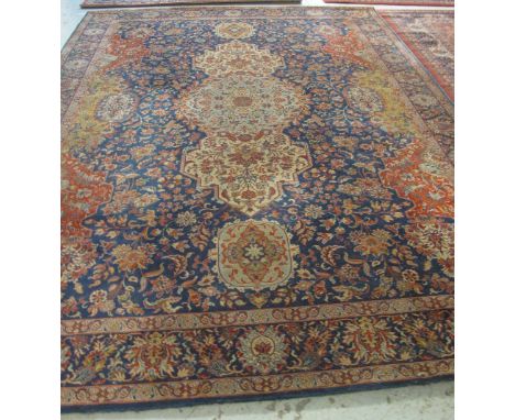 Large machine made Persian design floral and foliate blue and red ground carpet, 350 x 250cm.(B.P. 24% incl. VAT)