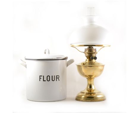 A vintage enamel flour bin, cylindrical form, 27cm high, and a brass oil lamp with opaque glass shade.