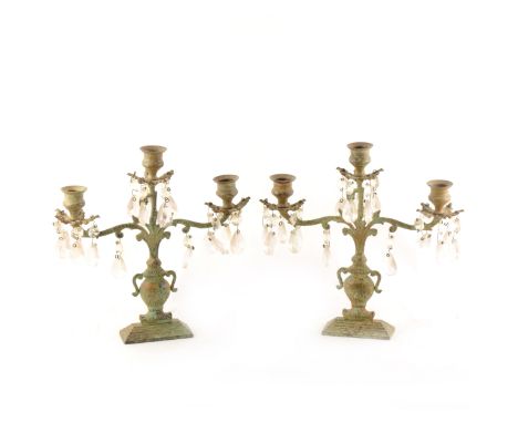 A pair of contemporary patinated metal three-light candelabra, glass droplets, urn-shape bases, 27cm.
