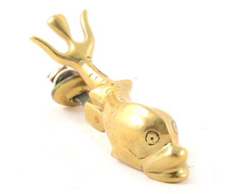 A heavy cast brass door knocker, designed as a fish.