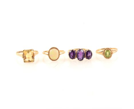 Four 9 carat gold semi-precious gemset rings, an amethyst three stone ring, maximum width at front 10mm, ring size Q, a recta