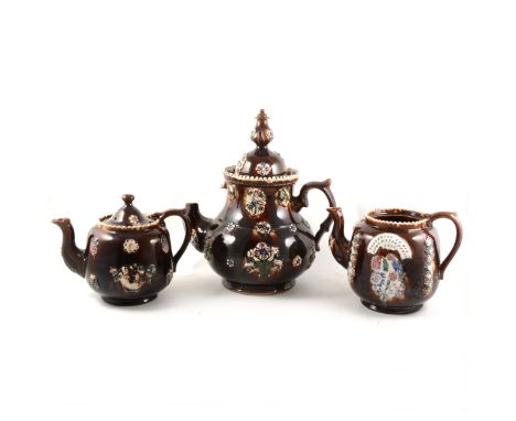 Three Bargeware teapots, one with plaque stamped 'Presented to Mrs John Hayens Derry 1883' (lacking cover), the largest teapo