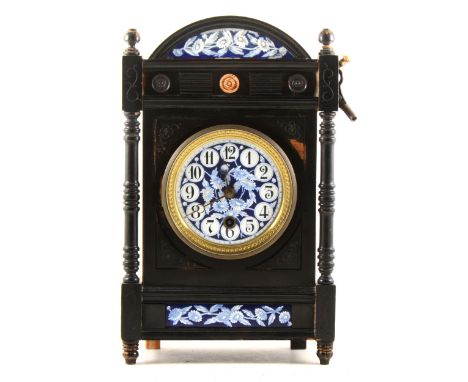 An Aesthetic movement ebonised mantel clock, with blue ground enamel dial and panels, spring driven movement, case labelled T