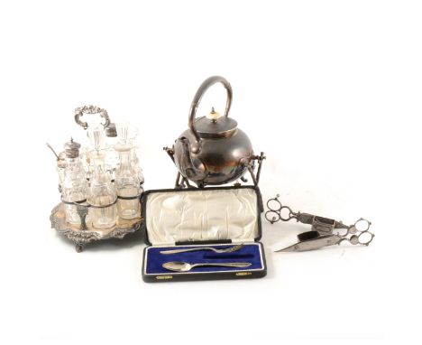 An electroplated spirit kettle on stand in the form of tree branches, a seven piece cruet set on plated stand, with three gla