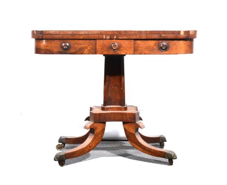 A Victorian rosewood card table, the tapering column raised on a shaped base on four down-swept supports, brass caps and cast