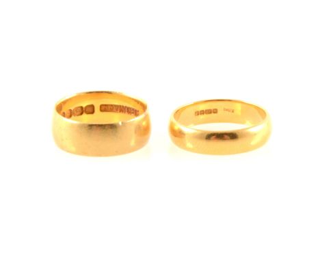 Two 22 carat yellow gold wedding bands, a 7.6mm wide plain polished half D shape band, hallmarked London 1969, approximate we