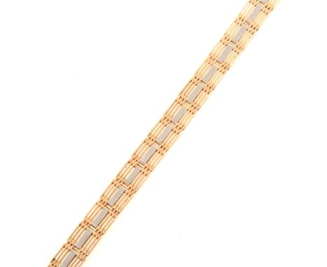 A yellow and white metal gate bracelet, six yellow metal bars and central white metal bar, overall width 10.5cm, fifteen link