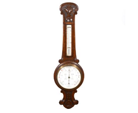 An Edwardian carved oak aneroid wall barometer, banjo shape case, the dial inscribed 'Admiral Fitzroy's Identifications', 95c