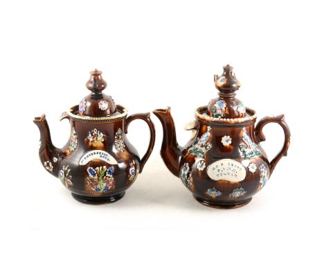 Two Bargeware teapots, teapot finials, with plaques stamped 'For Home Sweet Home' and 'Mr R Terry, R.A.M.O. Fulham', 28cm and