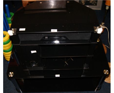A black glass media stand with an incorporated sound bar and speaker together with a black glass coffee table