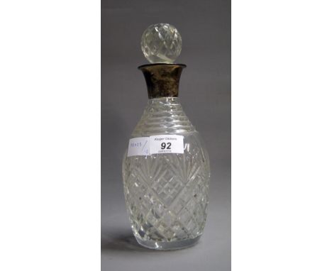 A silver-mounted cut-glass decanter with its stopper CONDITION REPORT; Available on request. Catalogue descriptions and condi