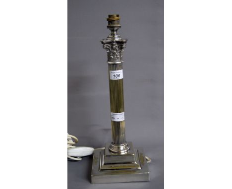 A silver-plated table lamp of columnular form with electric fitting CONDITION REPORT; Available on request. Catalogue descrip