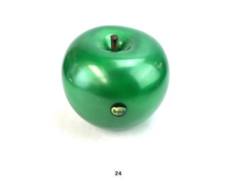 Large green sculpture of an Apple, possibly glazed ceramic with stamp to base, with The Beatles badge, 10" diameter x 10" hig