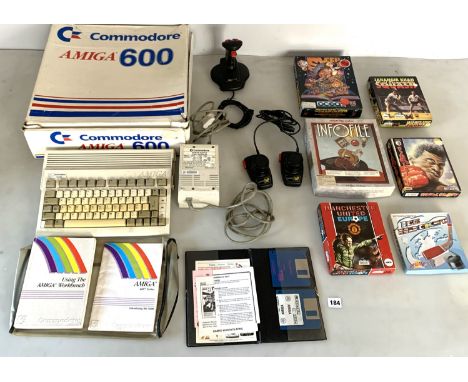 Commodore Amiga 600 console with box, power supply, joystick, paddles, instruction books, 6 boxed games and 2 empty game boxe