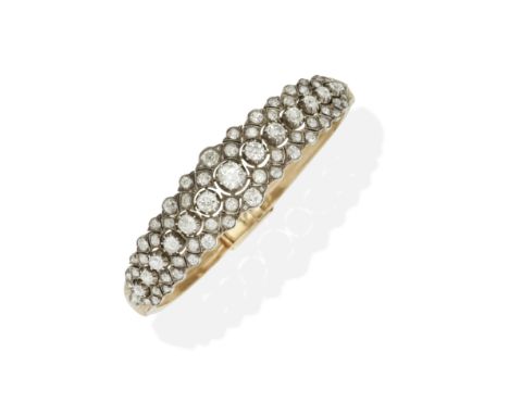 DIAMOND BANGLE, CIRCA 1890Of hinged openwork design, set to the front with old brilliant, rose-cut and cushion-shaped diamond