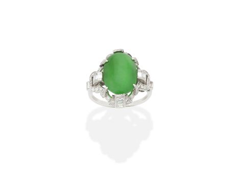 JADE AND DIAMOND RING, FIRST HALF OF 20TH CENTURYThe jade cabochon, within a baguette and single-cut diamond halo, between si