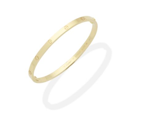CARTIER: 'LOVE' BANGLEWith screwhead motifs, signed Cartier, maker's mark, numbered, Swiss assay mark, European convention ma