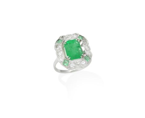 EMERALD AND DIAMOND RINGThe step-cut emerald, weighing 3.97 carats, within an old brilliant-cut diamond and calibré-cut emera