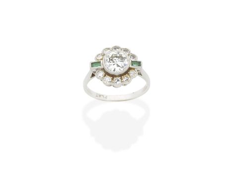 EMERALD AND DIAMOND RING, CIRCA 1930The old brilliant-cut diamond within a scalloped similarly-cut diamond border, between st