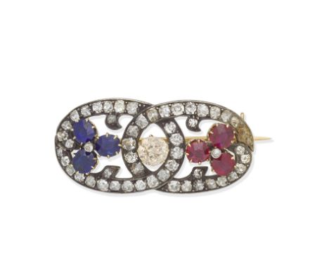 DIAMOND, SAPPHIRE AND RUBY BROOCH, CIRCA 1900The old brilliant-cut diamond of brown tint between trefoils of cushion-shaped r