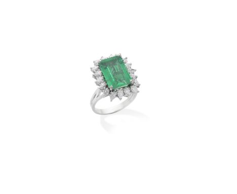 EMERALD AND DIAMOND CLUSTER RINGThe step-cut emerald within a pear-shaped diamond border, emerald very approx. 5.20, diamonds