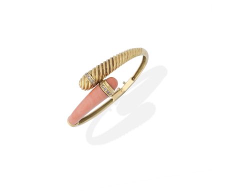 JEAN &amp; PIERRE BELLIN: CORAL AND DIAMOND-SET BANGLE, CIRCA 1970Of hinged design, the carved coral corallium rubrum, with r