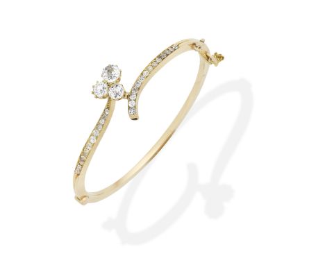 DIAMOND BANGLE, LATE 19TH CENTURYThe hinged bangle set with an old brilliant-cut diamond trefoil and cushion-shaped diamonds,