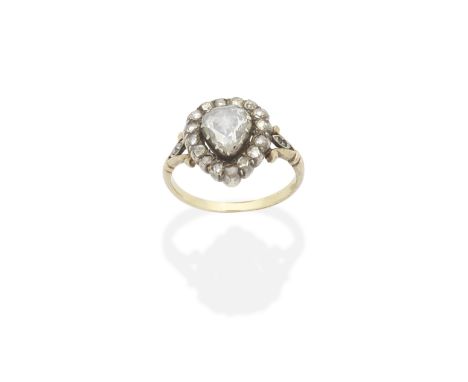 DIAMOND RING, LATE 18TH - EARLY 19TH CENTURYThe rose-cut diamond within a scalloped similarly-cut diamond border, between fle