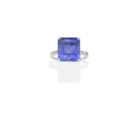 SAPPHIRE AND DIAMOND RINGThe step-cut sapphire, between pairs of baguette-cut diamonds, sapphire very approx. 13.90cts, ring 