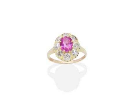 RUBY AND DIAMOND RINGThe oval-cut ruby within an old brilliant-cut diamond surround,  ruby very approx. 1.40cts, diamonds app