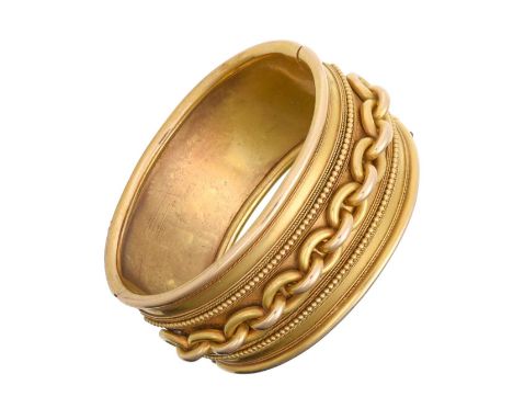 A Late Victorian Hinged Bangle the yellow broad bangle overlaid with a cable link motif centrally flanked by bead and rope wo